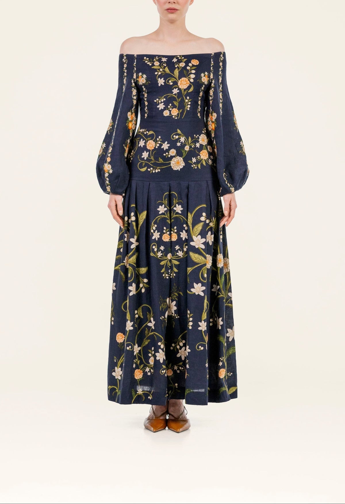 Front view of Senlis Valle maxi dress showcasing off-shoulder neckline, balloon sleeves, navy floral print on light background