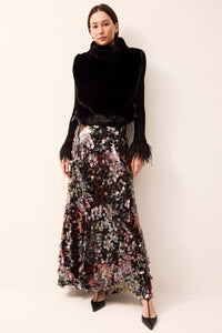 Cozy black faux-fur vest with a turtleneck and side ties for a customizable fit.