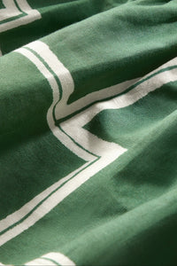 Sleeveless cropped top with green and white abstract print