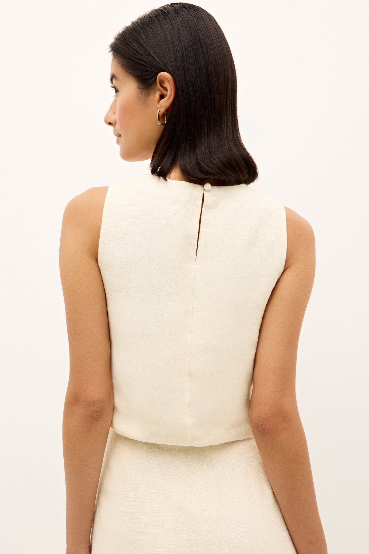 Bohemian inspired embroidered sleeveless top in a natural woven fabric