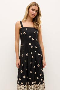 Printed black dress with contrasting border pattern at the hem 