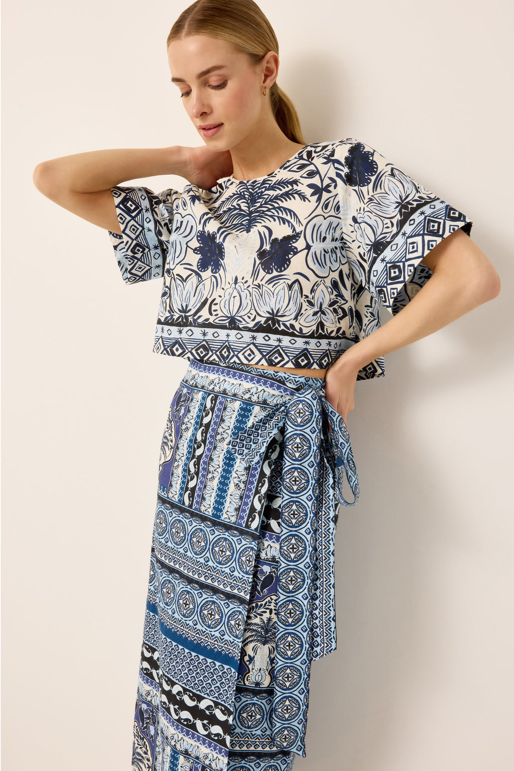 Cropped boxy fit blue and white floral printed top paired with a blue geometric printed wrap skirt