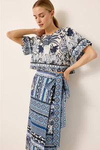 Cropped boxy fit blue and white floral printed top paired with a blue geometric printed wrap skirt