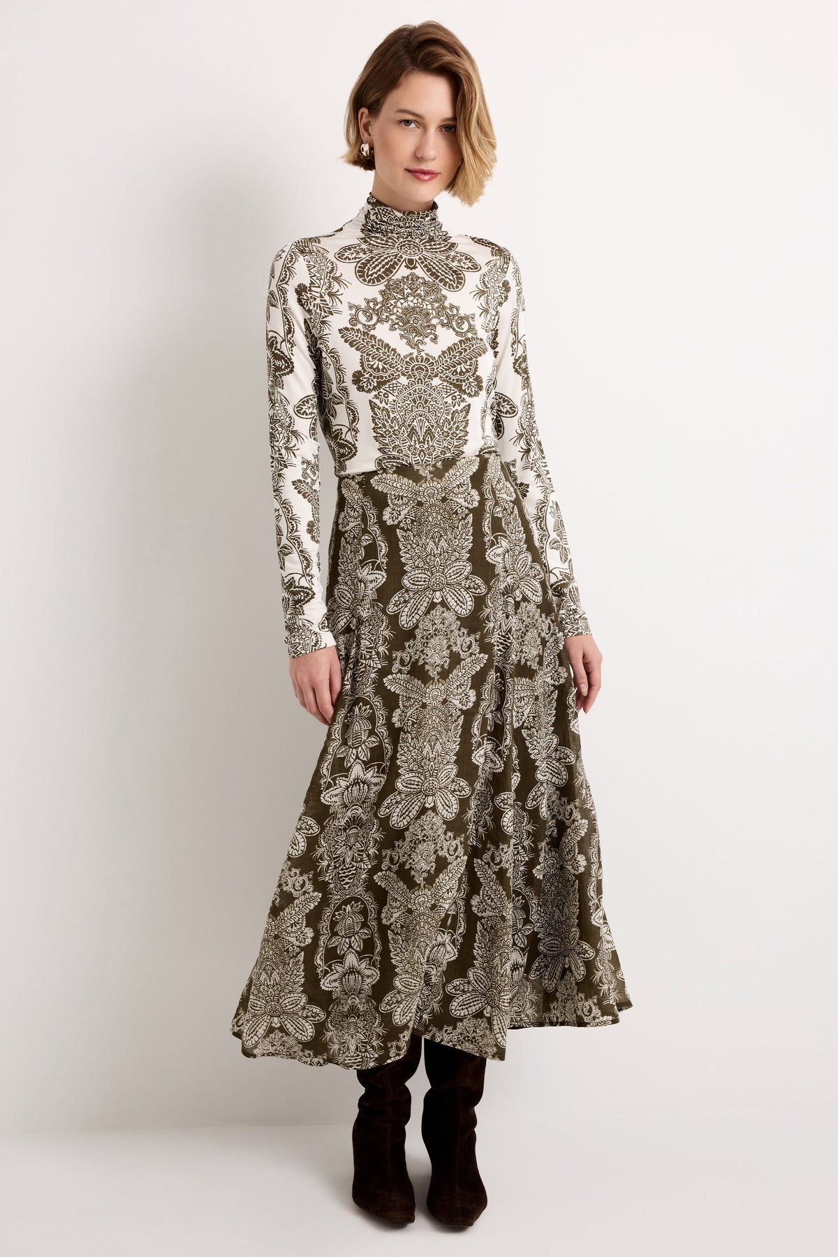 Front view of Emryn Skirt in Verdelle showing olive green and white placed print and A-line maxi fit on a model