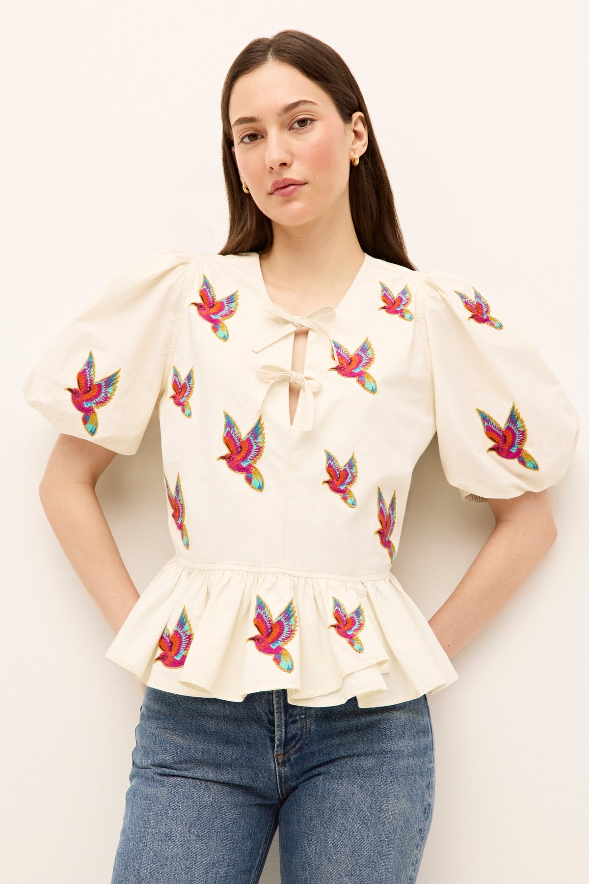 Ivory peplum blouse with puff sleeves and colorful parrot embroidery 
