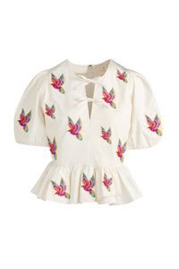 Floral inspired peplum top with voluminous sleeves and tropical design accents 