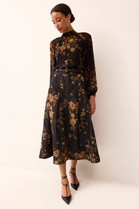 midi structured skirt and an all over black and gold pring and a fitted waist