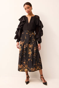 Black and gold printed midi skirt with a tailored fit and structured design.