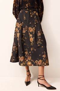 Structured black midi skirt featuring a fitted waist and allover gold print.