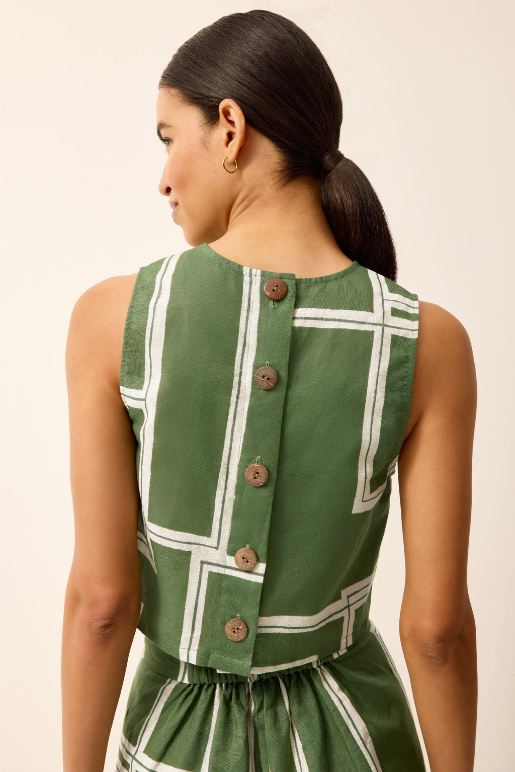 Green and white top with buttons down the back