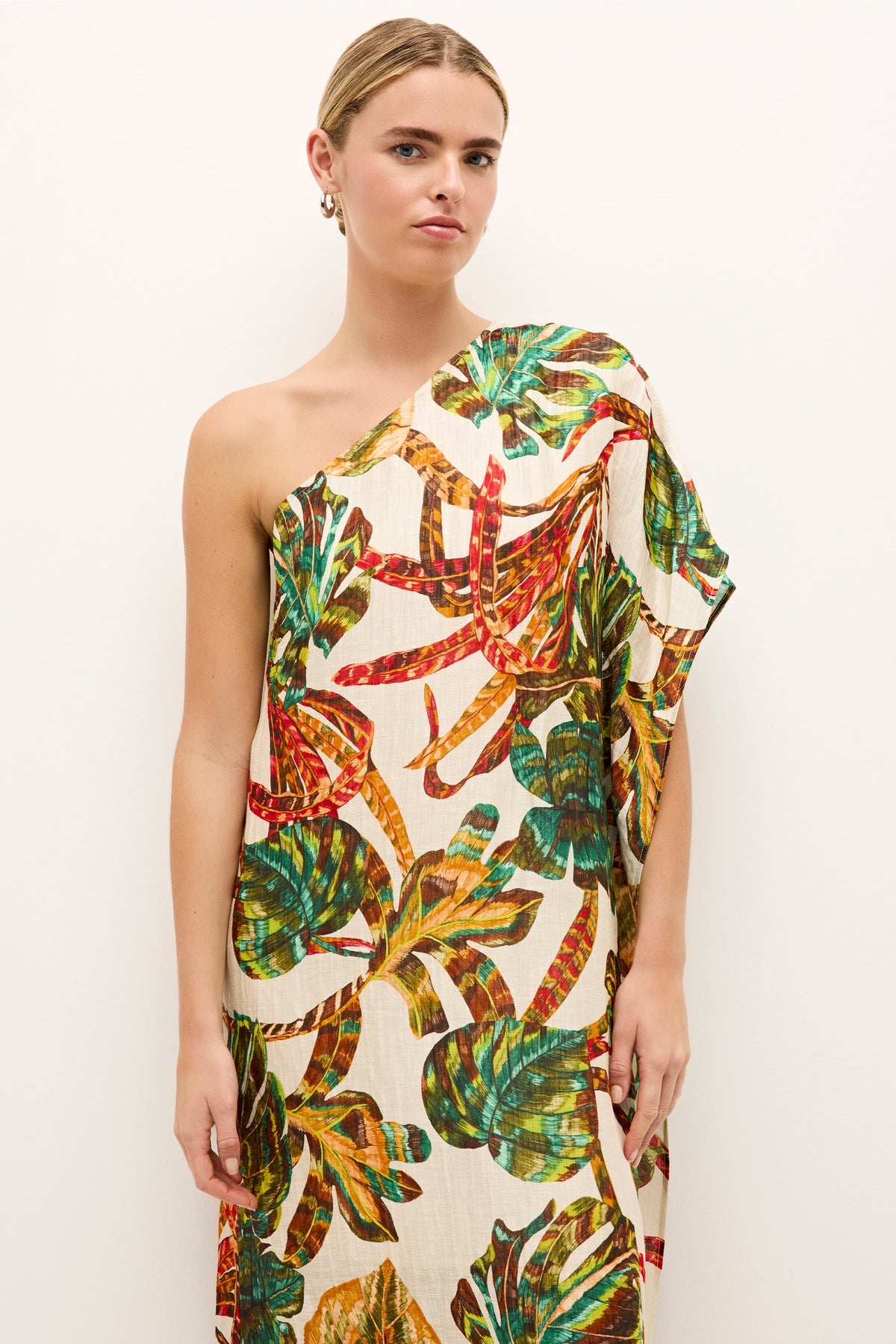 Asymmetrical dress with a belted waist and vibrant botanical pattern 