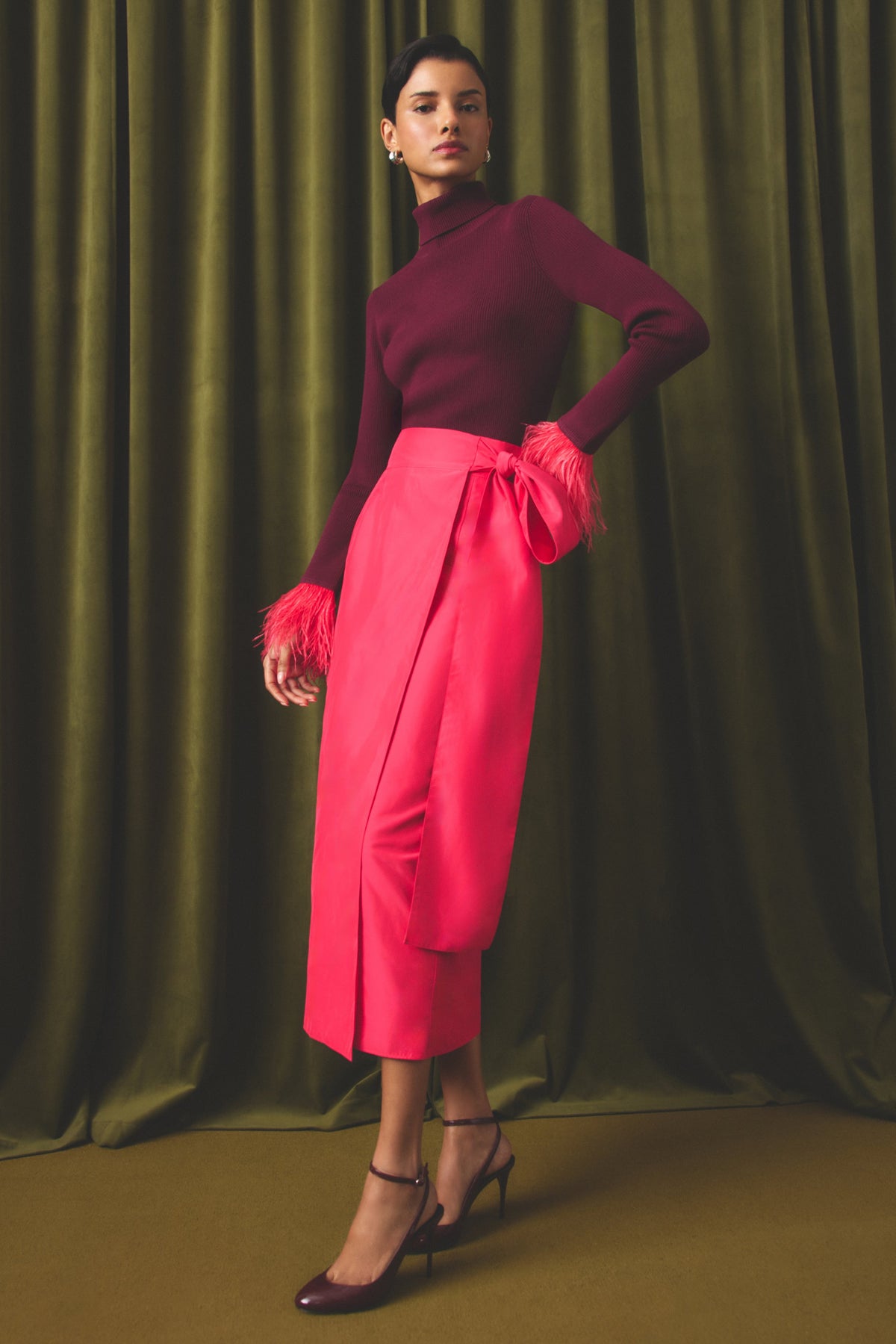 Straight bright pink wrap skirt with a dramatic bow detail at the waistline.