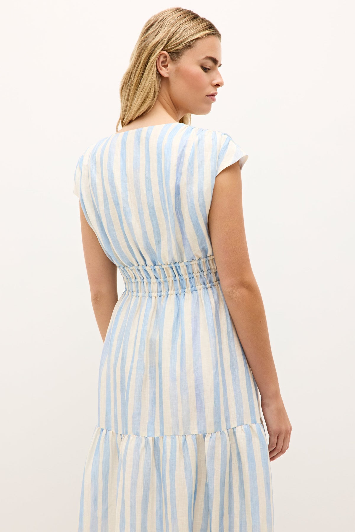 Blue and white vertical stripe dress with ruched waist and flowy silhouette