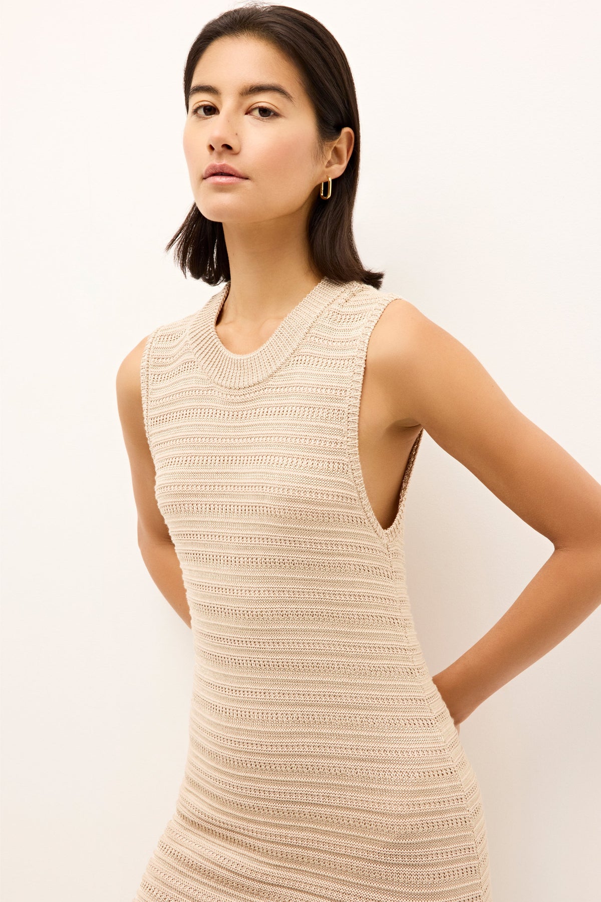 Minimalist sleeveless dress with crew neckline and lightweight texture