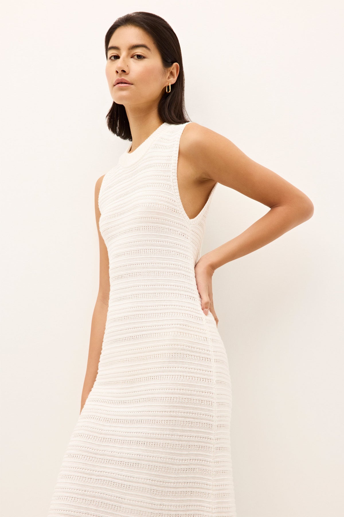 minimalist white sheath dress with a round neckline and ribbed horizontal detailing