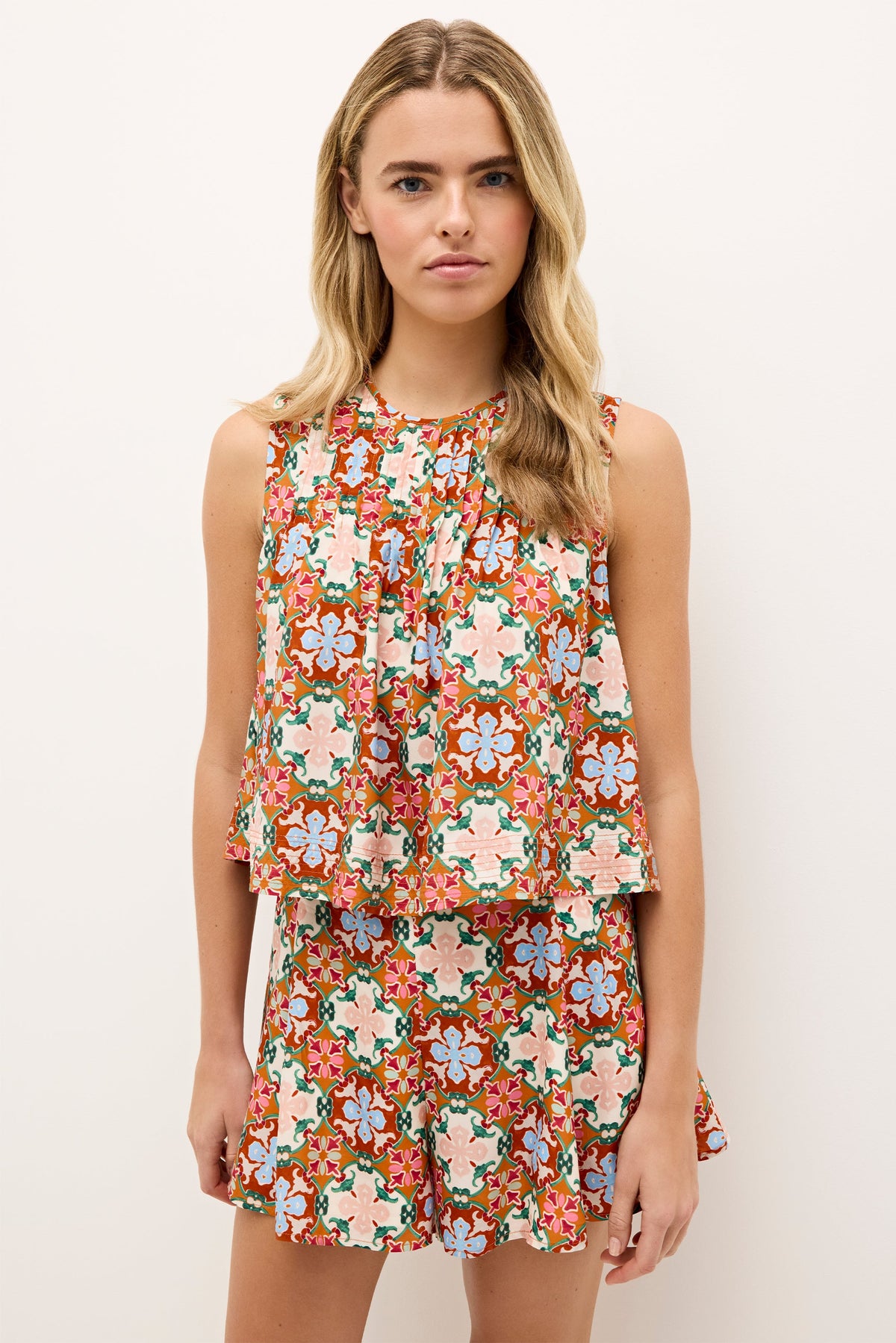 Rust, pink, and blue patterned top with a breezy, cropped cut