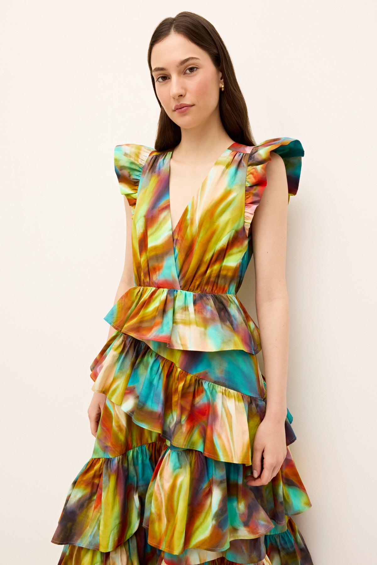 Colorful V-neck dress with dramatic shoulder ruffles and a flared tiered silhouette 