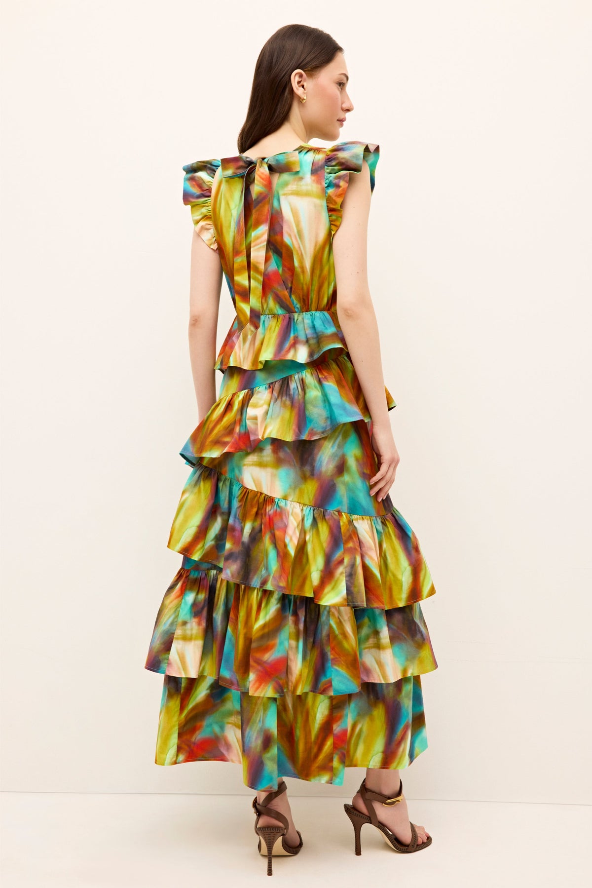 Maxi length dress with flutter sleeves, deep V-neck, and layered ruffle design 