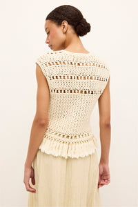 Boho inspired cream top with looped stitching and a fringed bottom edge
