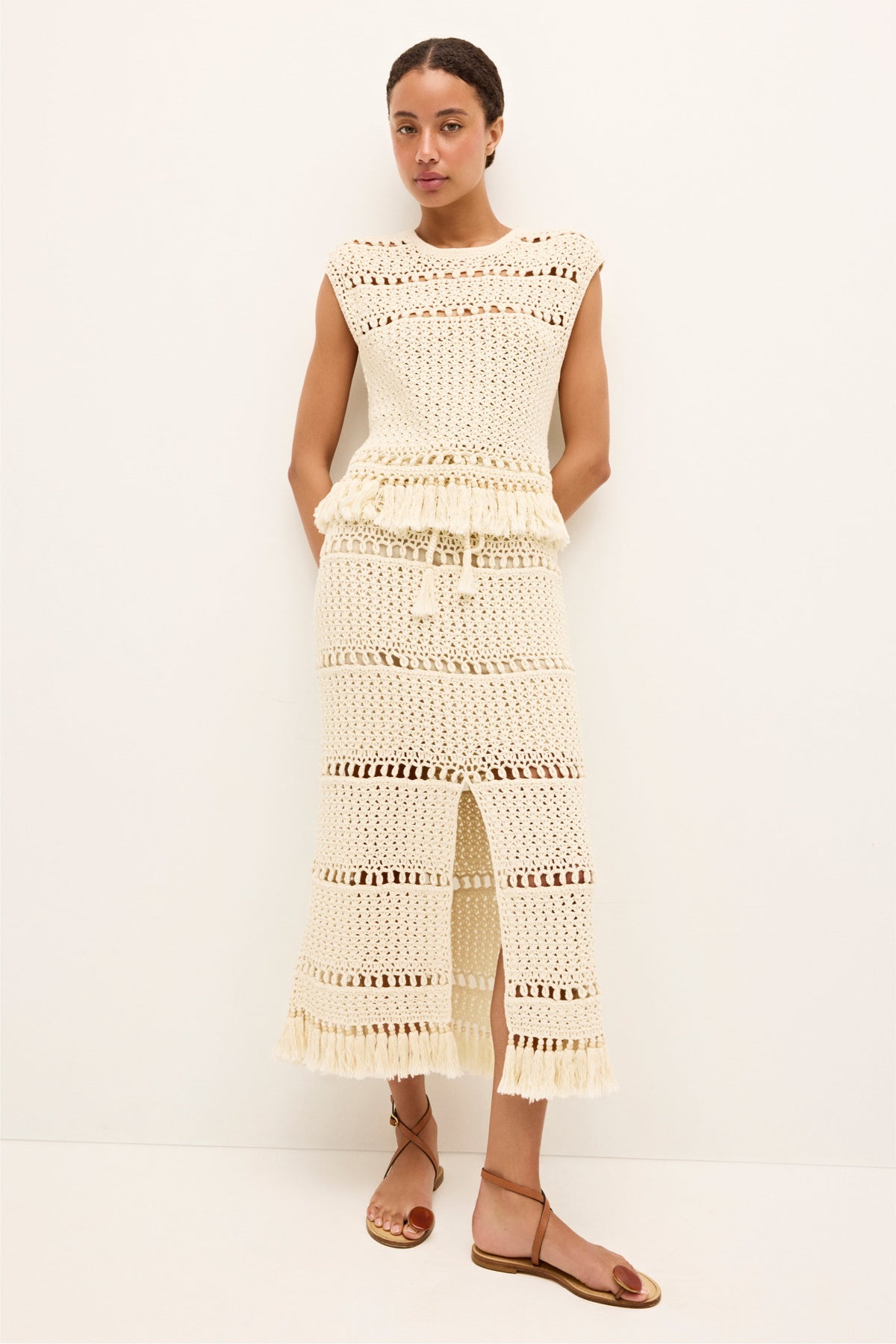 Crochet sleeveless top in off white with geometric knit panels and fringe details