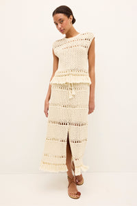Lightweight open knit cream blouse with decorative loops and hem tassels