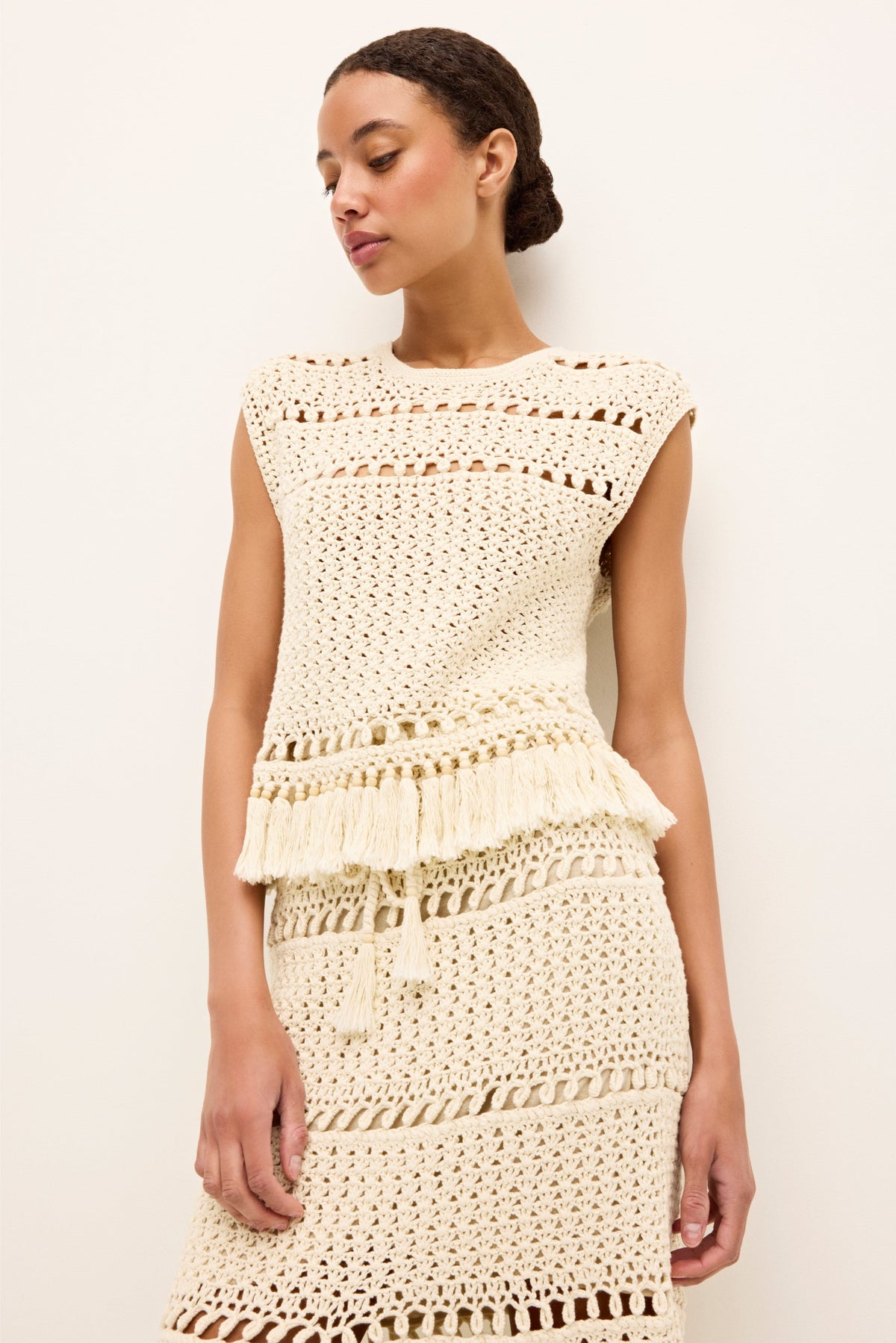 Vintage style crocheted top with cap sleeves and bohemian fringe accents