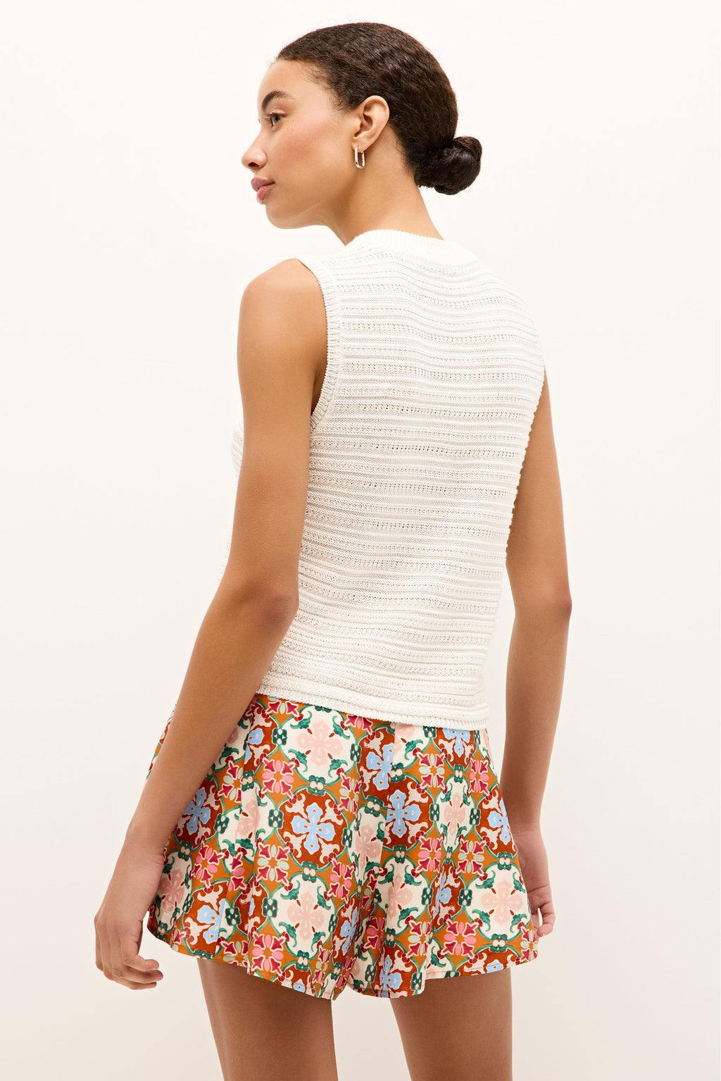 Minimalist knit top in ivory with a mock neck and a slightly cropped hem