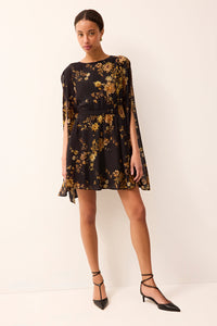 Elegant mini dress featuring flowing cape sleeves, a fitted waist, and a black and gold floral design throughout.