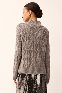 Gray cable-knit sweater with long sleeves, a mock neck, and subtle silver metallic threads woven throughout.