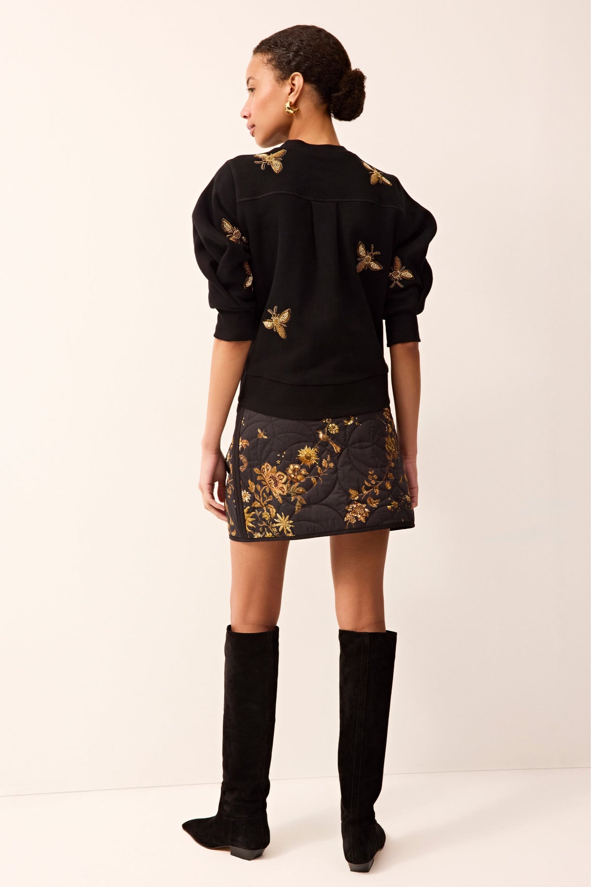 Elegant black sweater with puffed half sleeves and intricate beaded bee embellishments throughout.