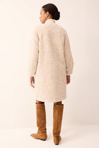 Creme jacket in a sherpa material with elevated buttons 