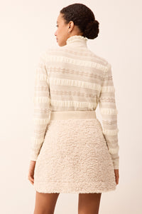 Cozy sherpa mini skirt with a wrap design and adjustable button waist.