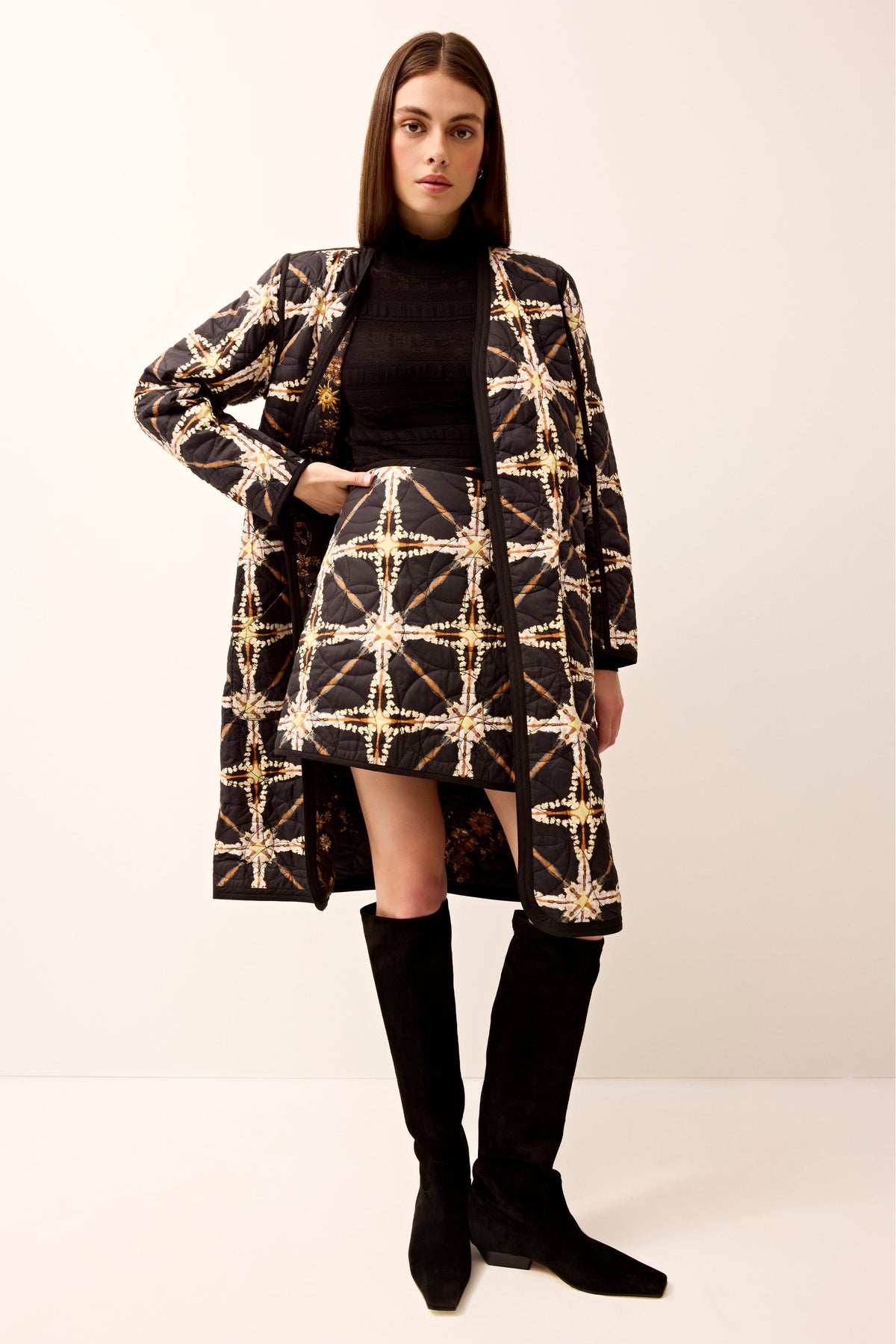 Reversible long sleeve quilted jacket with a belt