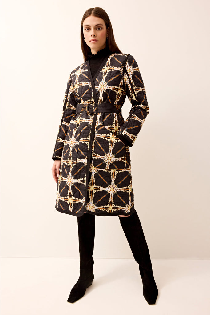 Reversible quilted long-sleeve jacket featuring a waist belt.