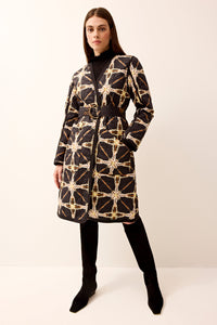 Reversible quilted long-sleeve jacket featuring a waist belt.