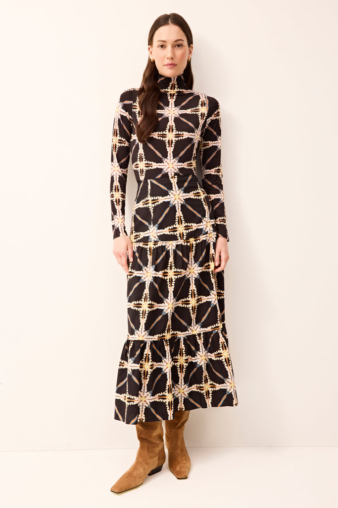 Mock neck fitted top with long sleeves and subtle patterned detailing.