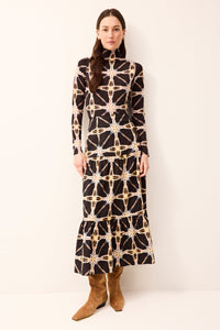 Mock neck fitted top with long sleeves and subtle patterned detailing.