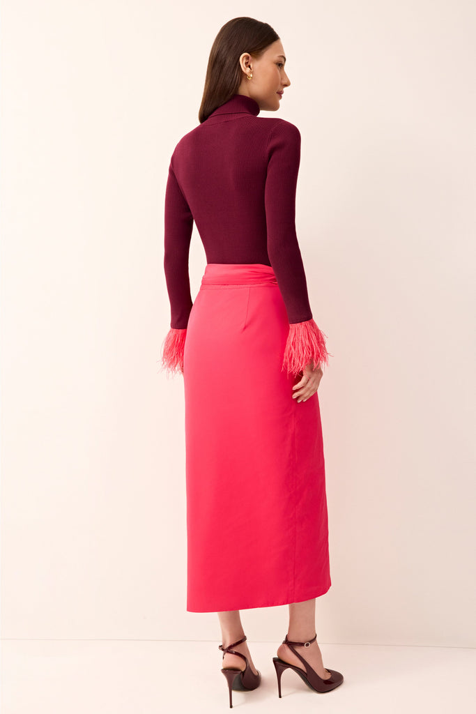 Elegant pink midi skirt with a wrap design and oversized waist bow.