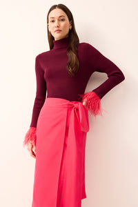 Bright pink wrap midi skirt featuring a statement bow at the waist.