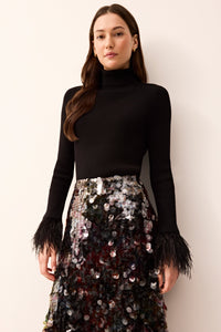 Black long sleeve knitwear turtleneck thats form fitting with black feather all over the hem of the sleeves 