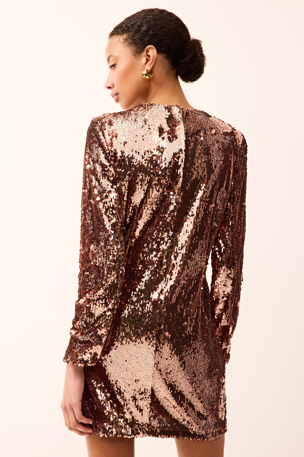 Pink long sleeve sequin mini dress with rounded neckline