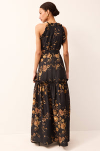 Black formal halter dress with a ruffled skirt and allover gold floral pattern.