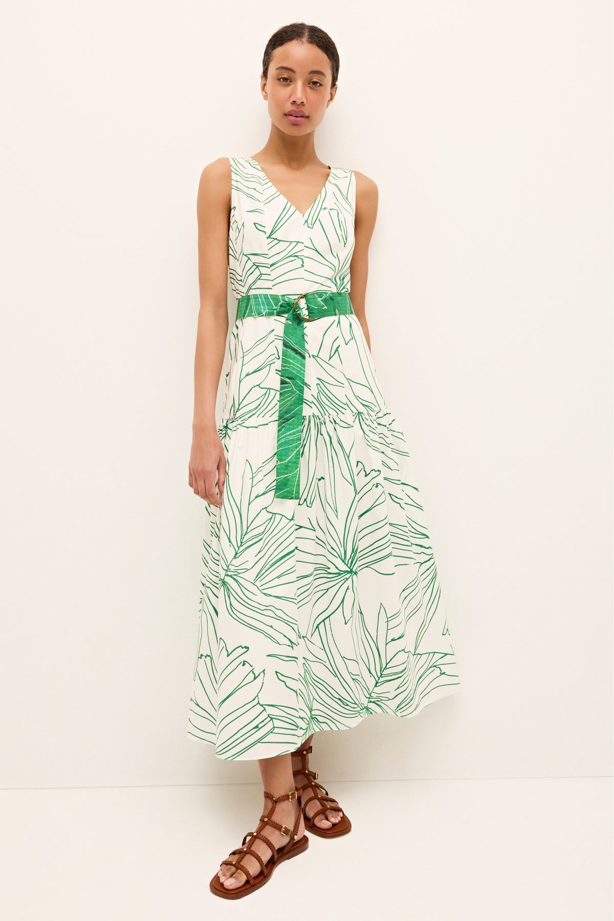 Elegant sleeveless dress with botanical pattern and wide green sash belt