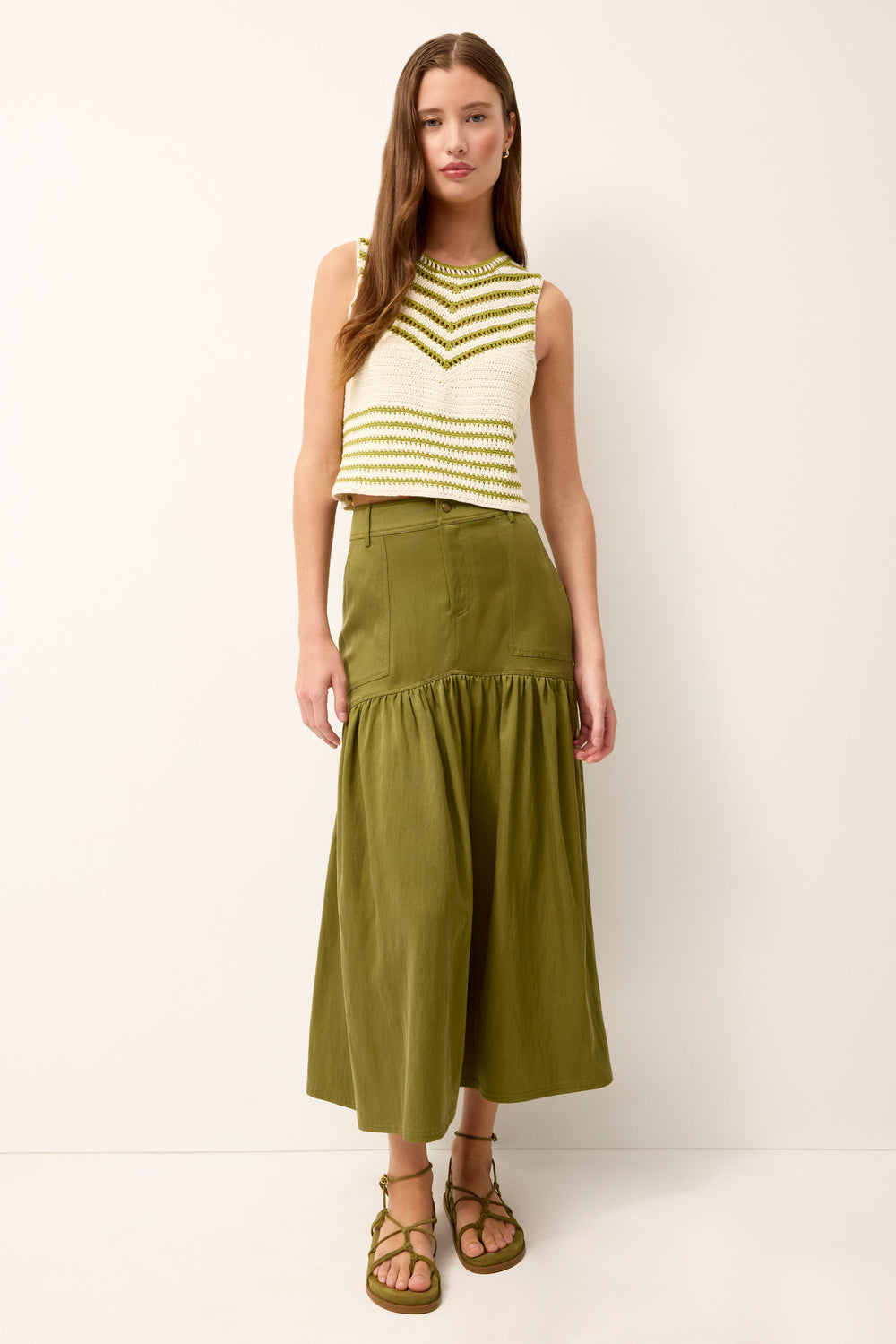 Front view of model wearing Sophie Skirt in Ivy showcasing curved drop-waist yoke and full midi-length silhouette against a white background