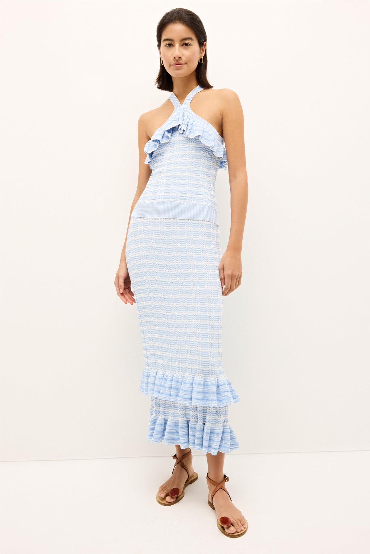Knit top with ruffle trim and crossover halter design