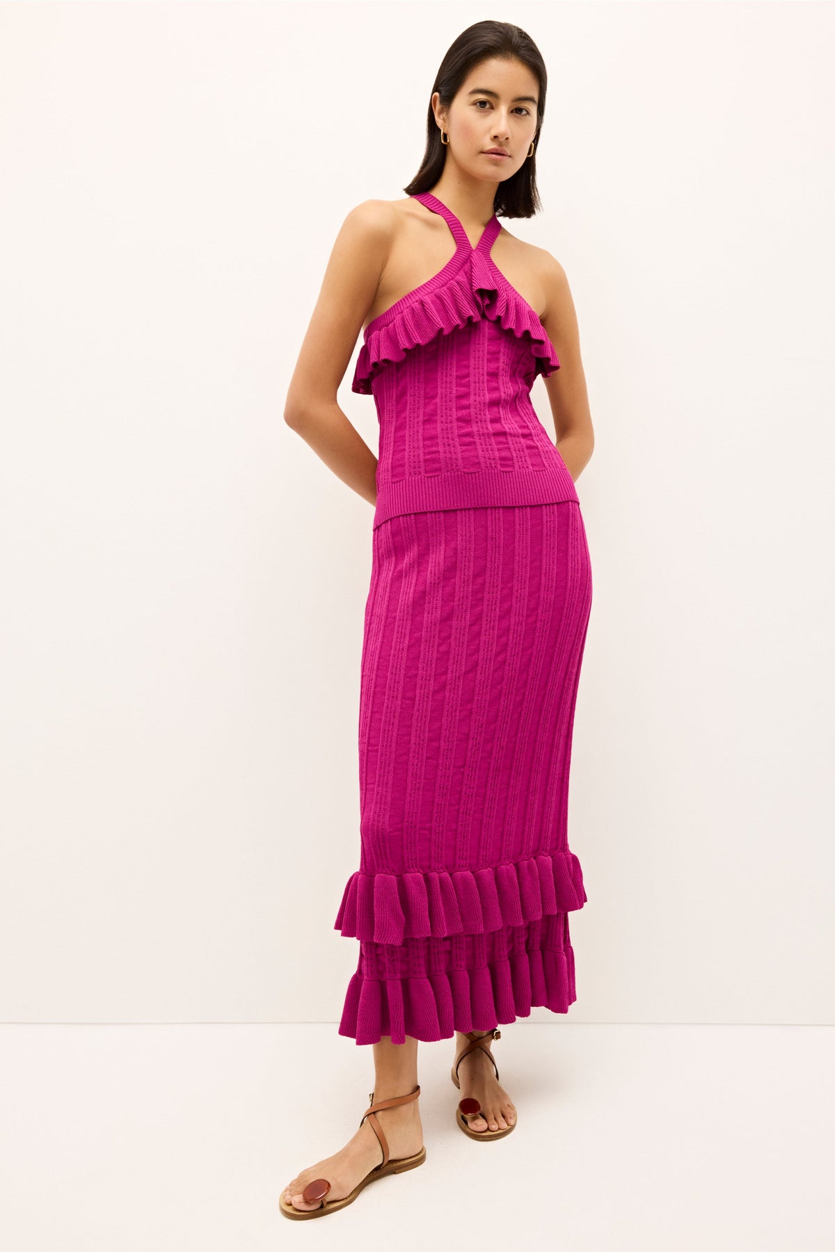 Bright pink fitted tank with a crossover halter neckline and flounder ruffle trim 