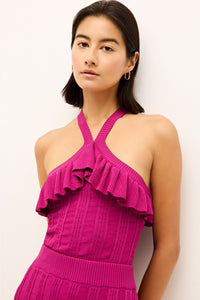 Sleeveless fuchsia top with a structured fit, cross-back straps and flirty ruffle neckline 