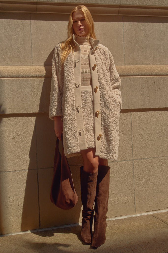 Textured beige coat with buttons down the front 