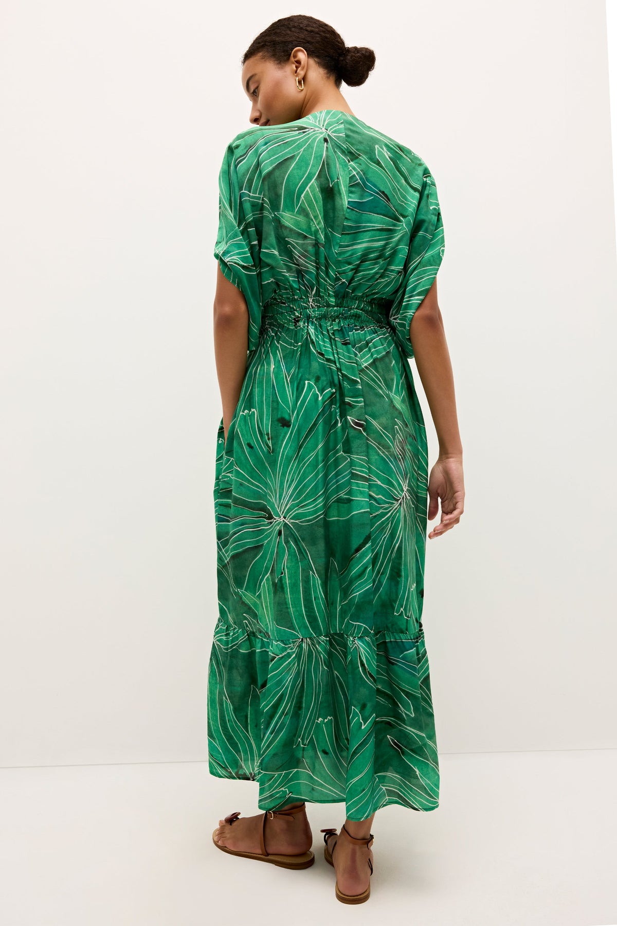 Green dress with white palm motifs and flowy silhouette