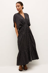 Boho inspired V-neck dress featuring cap sleeves and a flowy tiered skirt 